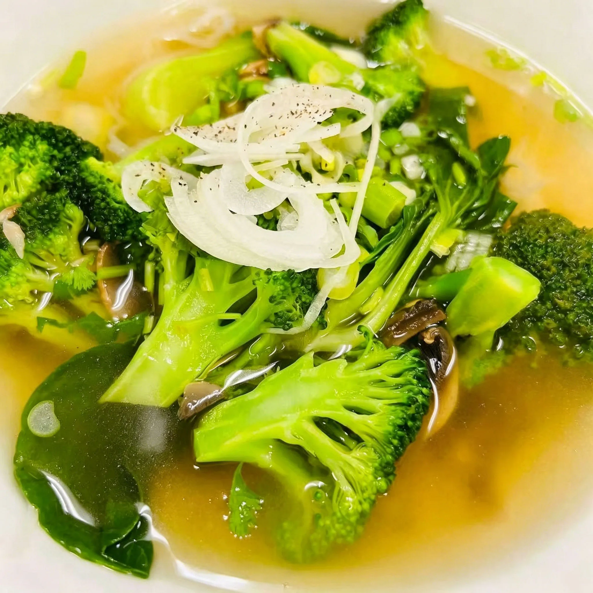 Vegetable pho noodle soup broccoli onion mushroom spinach clear broth white bowl at Su's Asian Street Kitchen, an Asian Fusion Restaurant in Westlake