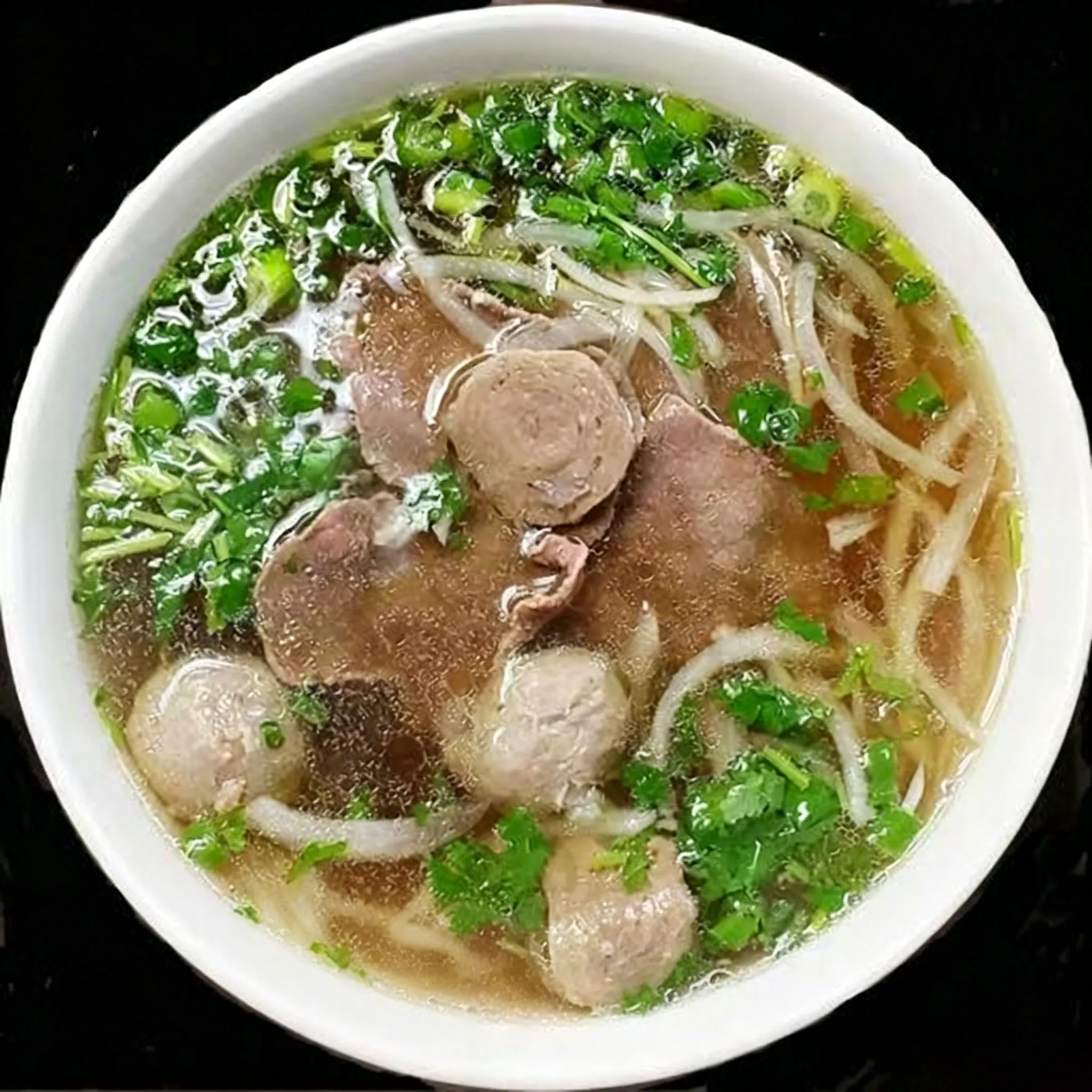 Vegetable pho noodle soup broccoli onion mushroom spinach clear broth white bowl at Su's Asian Street Kitchen, an Asian Fusion Restaurant in Westlake