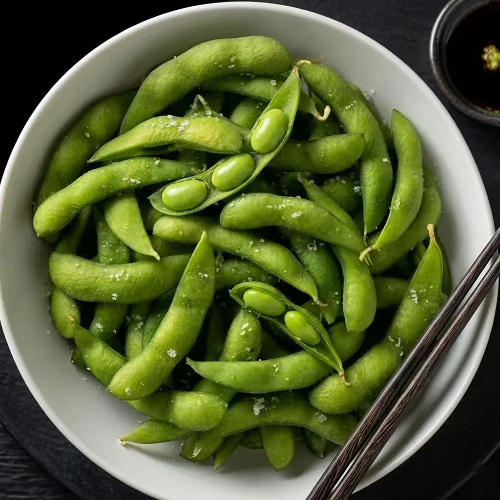 Salted steamed edamame whole pods soy sauce side bowl chopsticks white ceramic bowl at Su's Asian Street Kitchen, an Asian Fusion Restaurant in Westlake