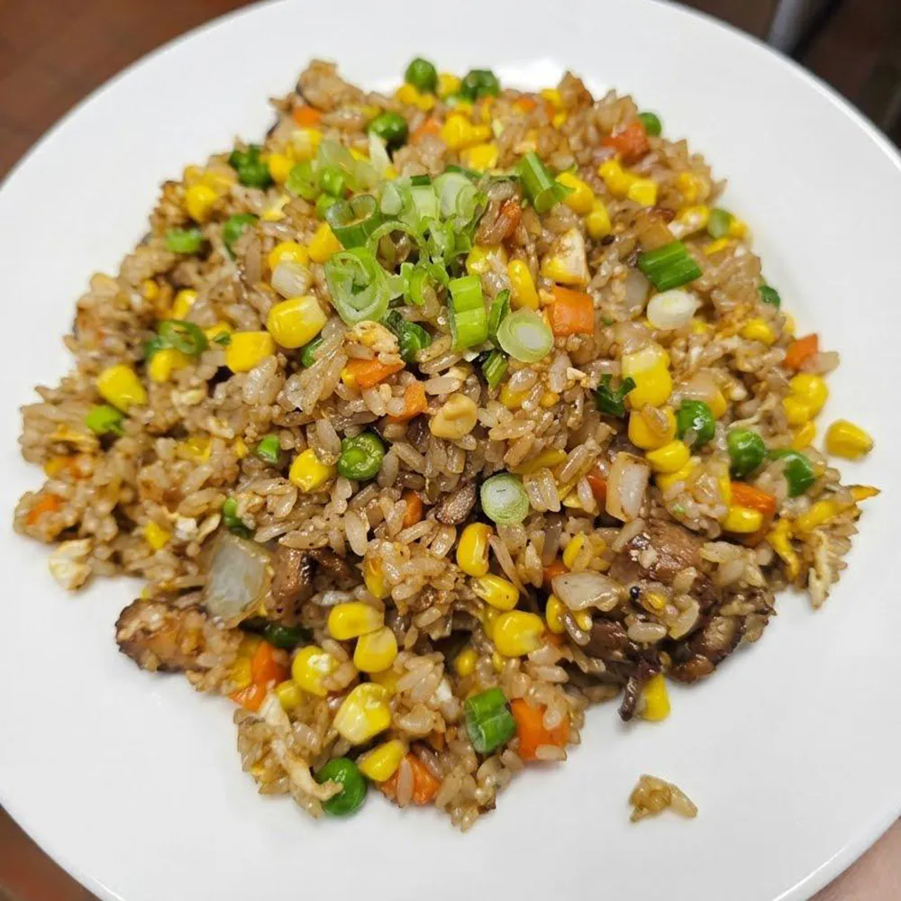 Classic vegetable beef fried rice corn pea carrot green onion garnish white plate at Su's Asian Street Kitchen, an Asian Fusion Restaurant in Westlake